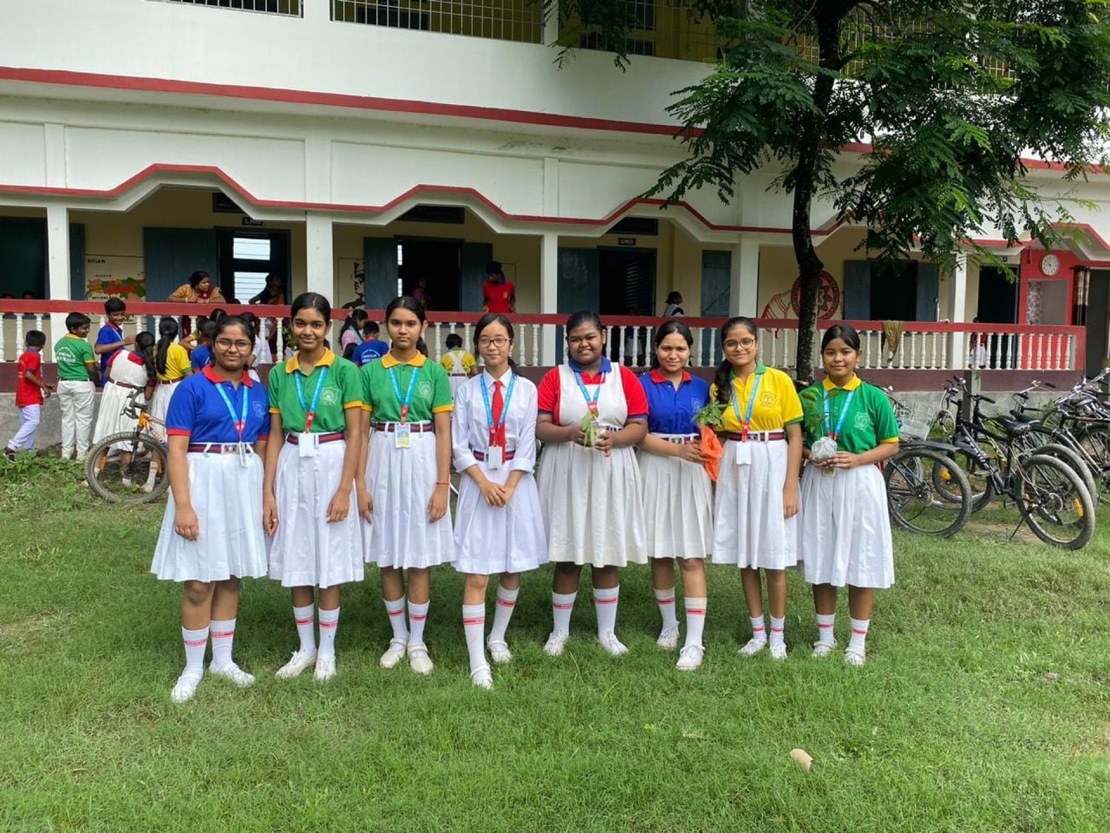 Senior students in school uniform outside the classroom block